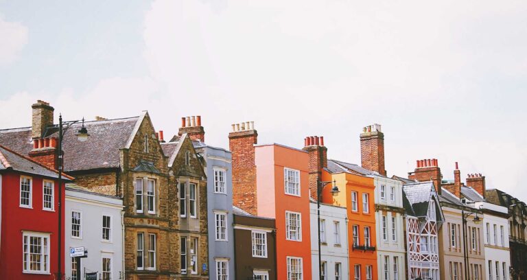 A row of buildings with different heights and colours