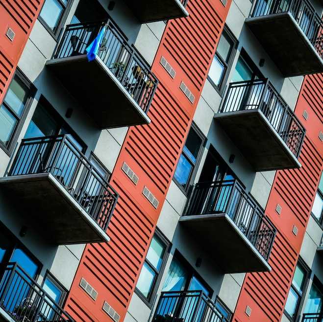 A zoomed in view of a high rise building with balconies